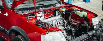 A car with the bonnet up in a workshop