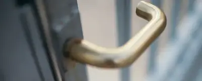 A hand at a door lock