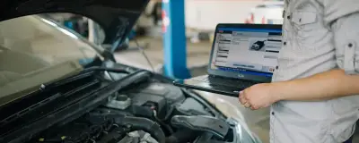 Mechanic reading vehicle diagnostic data