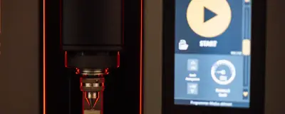 Machine part with a control screen in a workshop
