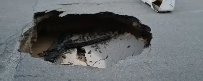 A pothole in the road surface