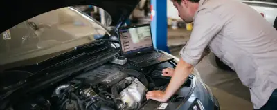 Diagnostic scanner connected to a car OBD port